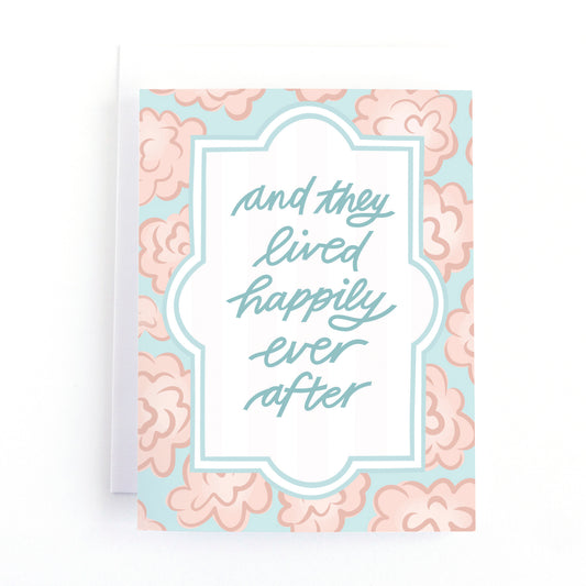 Elegant wedding card with hand-lettered “And They Lived Happily Ever After” and pink blooms. Perfect gift to celebrate love and the happy couple.