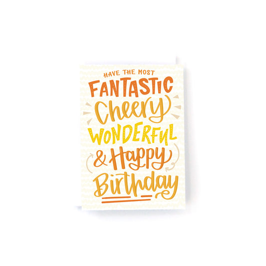 mini birthday card with orange and yellow hand lettering that says, have the most fantastic, cheery, wonderful and happy birthday on a white background.