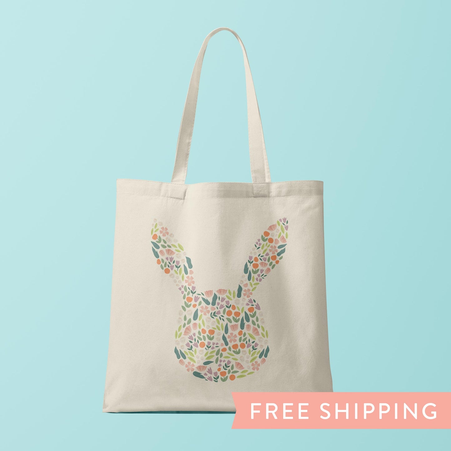 Canvas tote bag with a silhouette of a bunny rabbit filled with spring flowers.