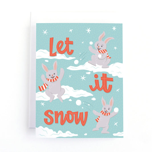 christmas card with bunnies having a snowball fight and the text, let it snow.