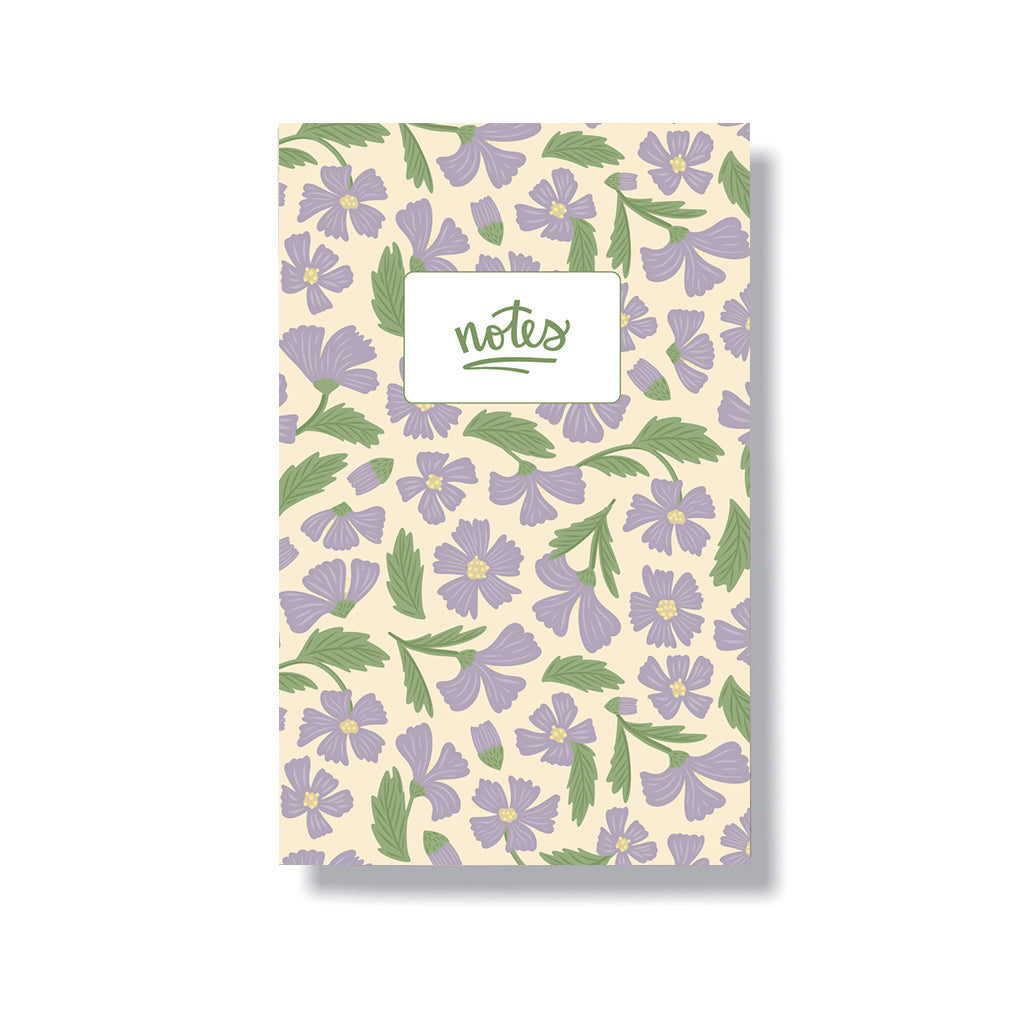 5.5x8.5" notebook with a laminated cover that has a hand drawn pattern with purple cosmos flowers. Inside has 6 lined pages.