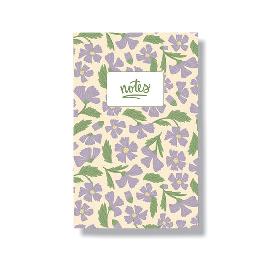 5.5x8.5" notebook with a laminated cover that has a hand drawn pattern with purple cosmos flowers. Inside has 6 lined pages.