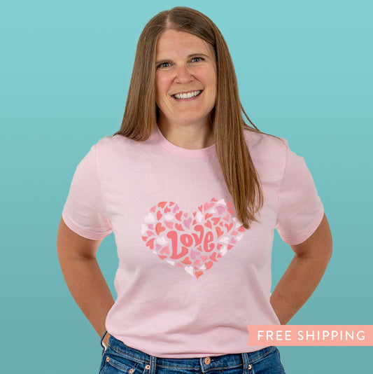 Women’s pink Valentine’s Day T-shirt with playful white and pink heart design. Soft, fun style perfect for gifting, casual wear, or treating yourself.