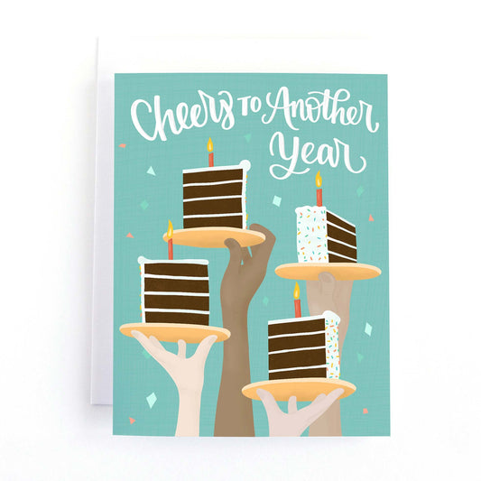 Birthday card with raised hands holding pieces of cake in a birthday toast and the text, Cheers to Another Year