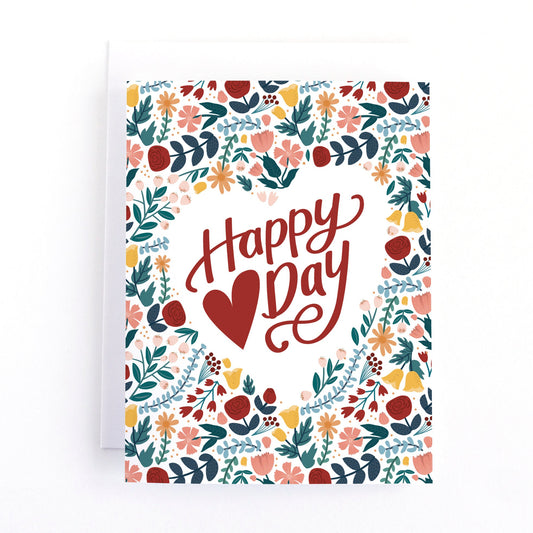 Valentine's Day Card with an intricate frame of flowers around the text happy heart day.