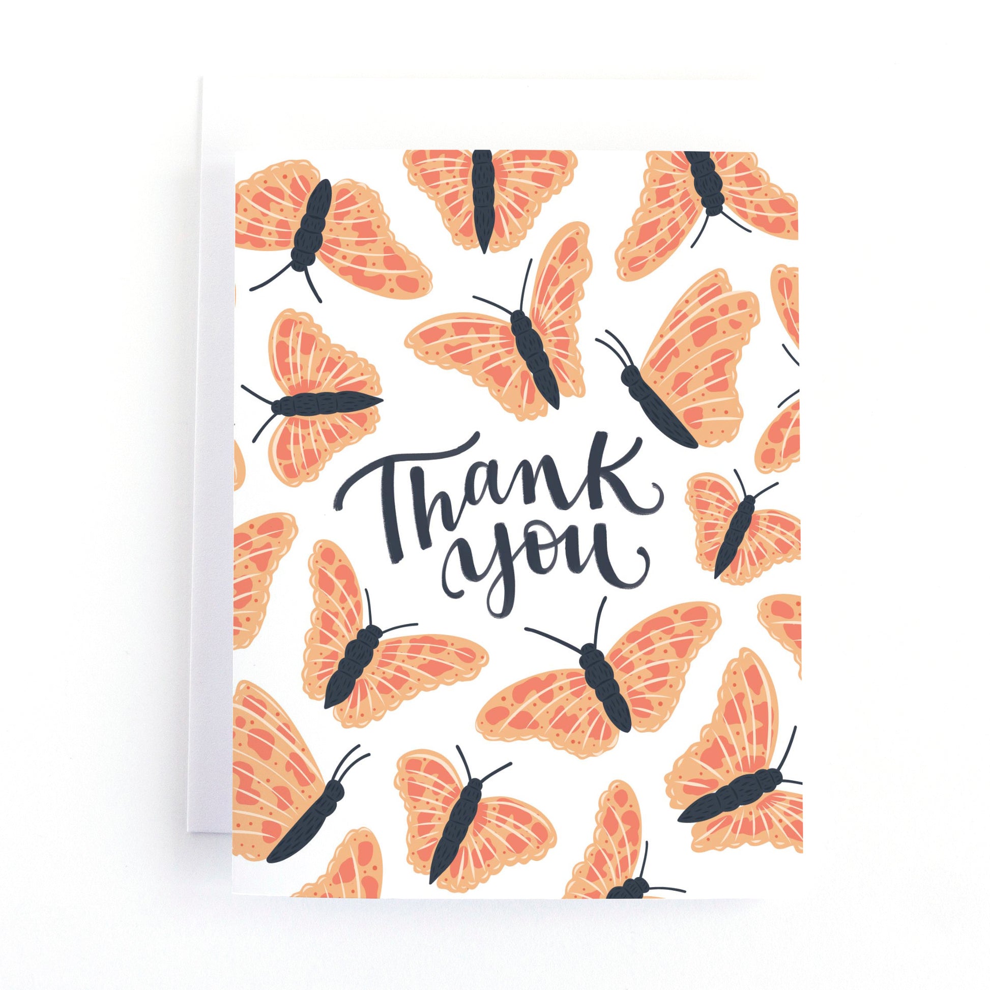 Thank you card with pink and coral butterflies fluttering around the hand lettered message, Thank you on a white background.