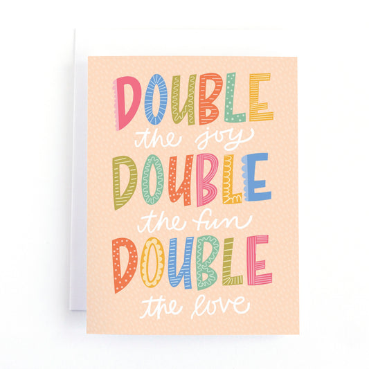 New baby card for twins with the handlettered greeting, Double the Joy, double the fun, Double the love in a colourful, gender neutral palette.