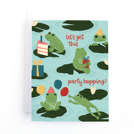 Frog and Pond themed brithday card with frogs wearing party hats on lily pads with balloons, cake and presents and the text, "let's get this party hopping!"