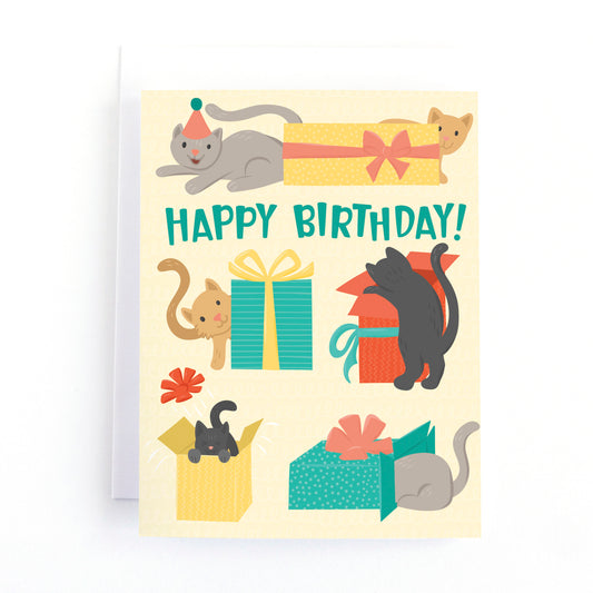 cat themed birthday card with playful cats plating in boxes and wrapped presents.

