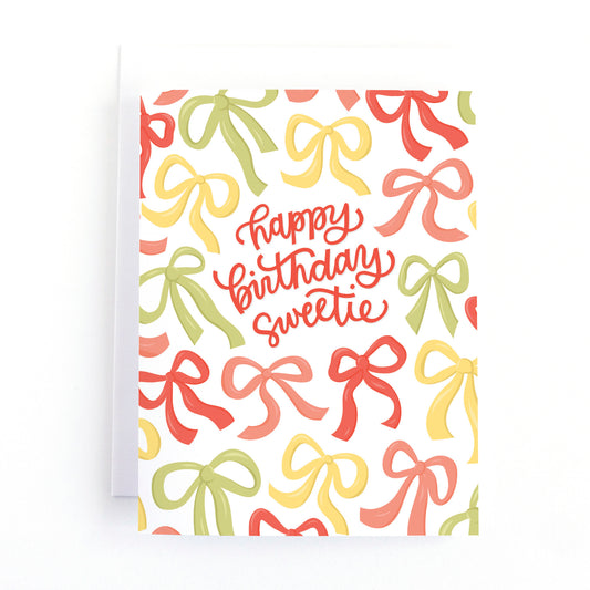 Girl's Birthday Card with hand drawn bows and ribbons surrounding the message, happy birthday sweetie.