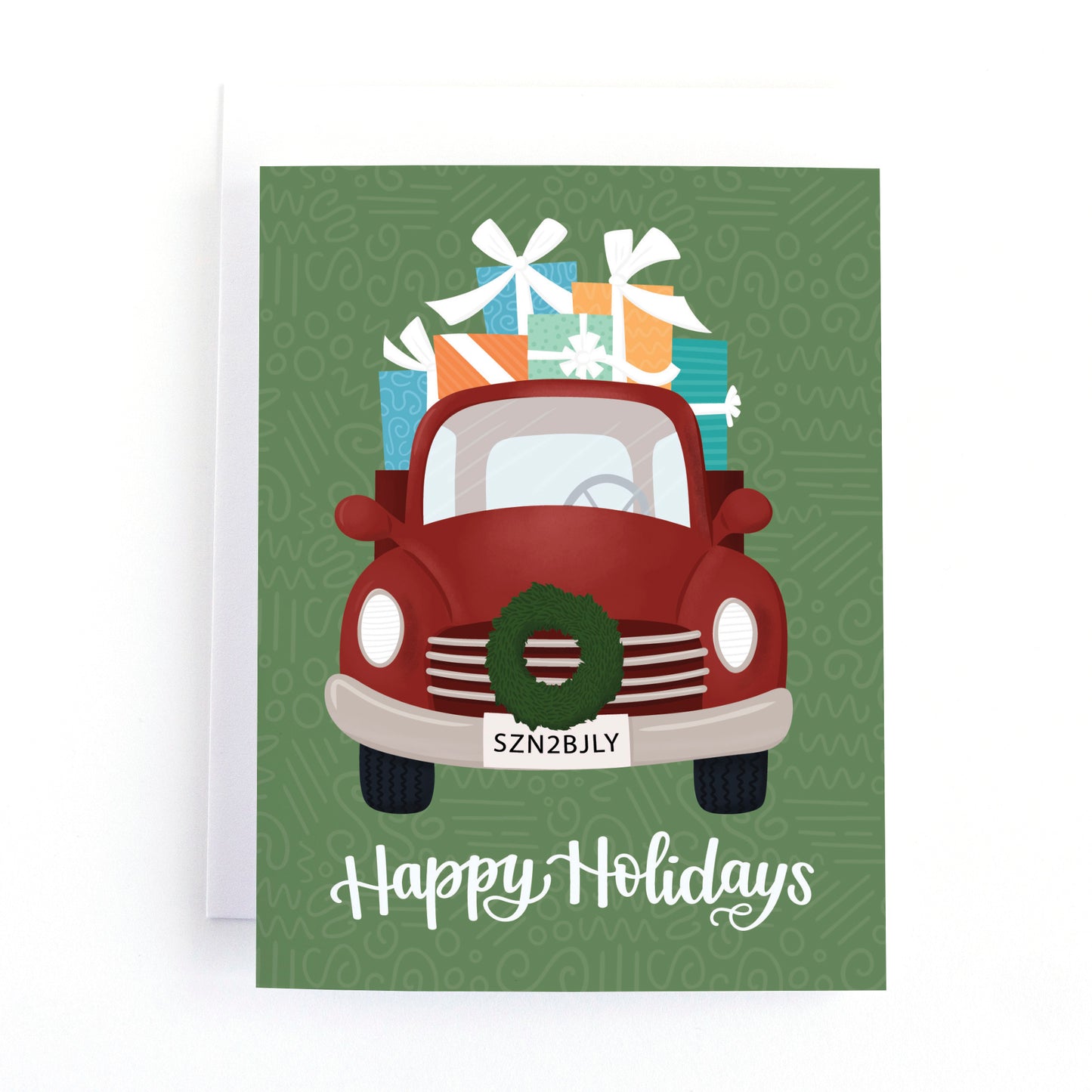 Christmas holiday card featuring a vintage red truck loaded up with gifts and the greeting, happy holidays
