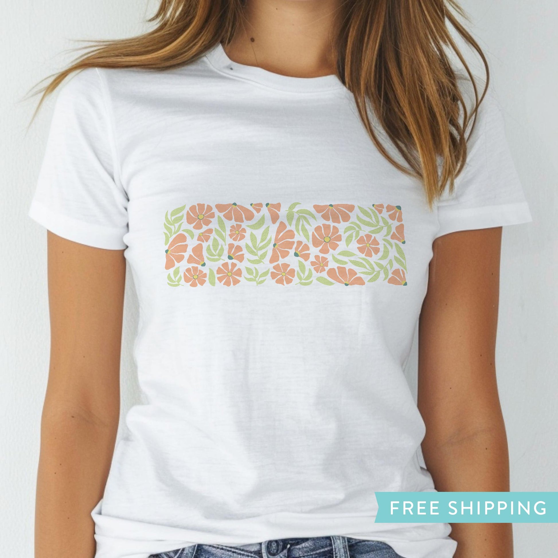 women's white graphic tee with pink spring flowers and green leaves