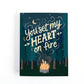 Valentine's Day Card with an illustration of a campfire in the woods under a starry sky with the text, you set my heart of fire.