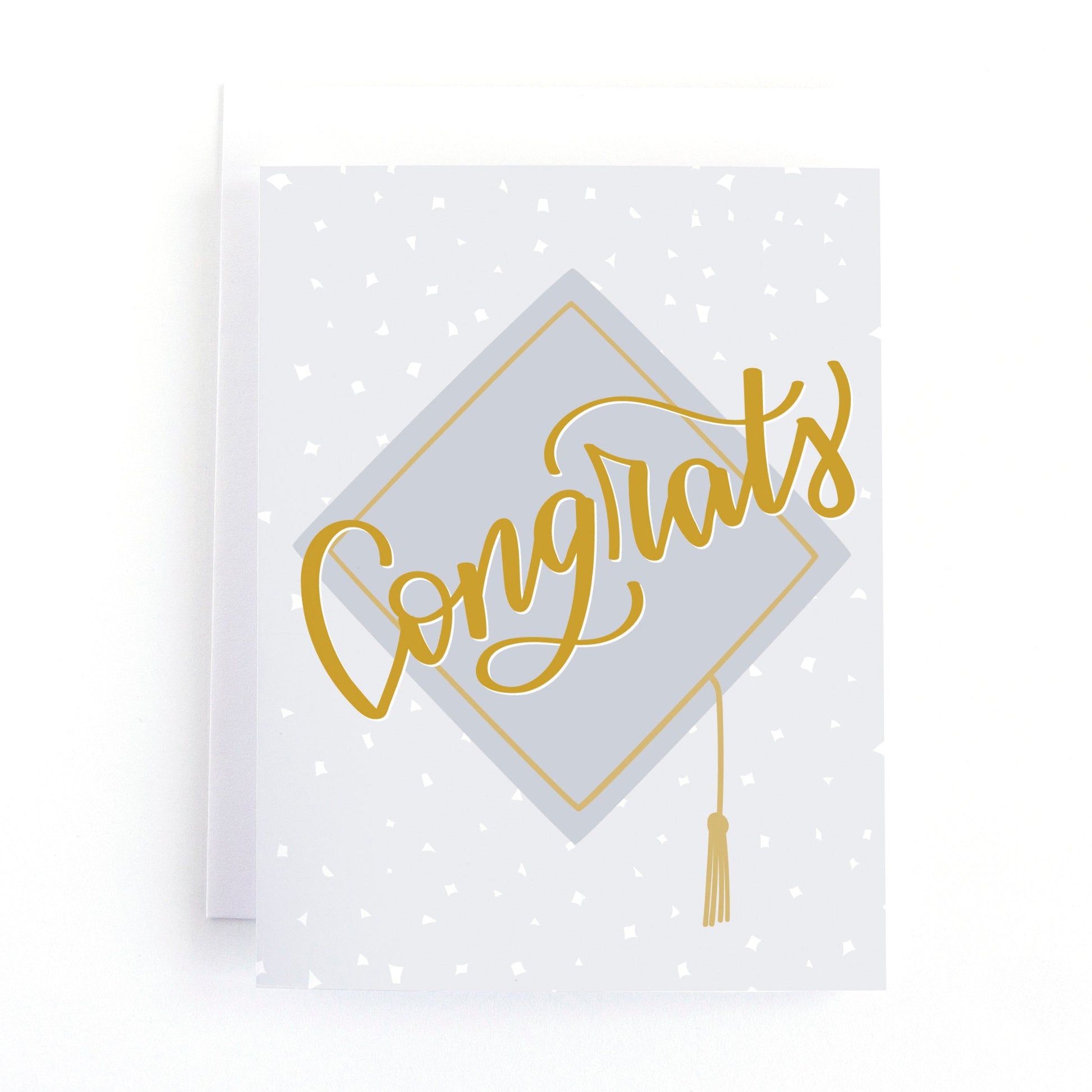 Graduation Card that says "congrats" in hand lettering script over an illustration of a graduation cap in grey and gold