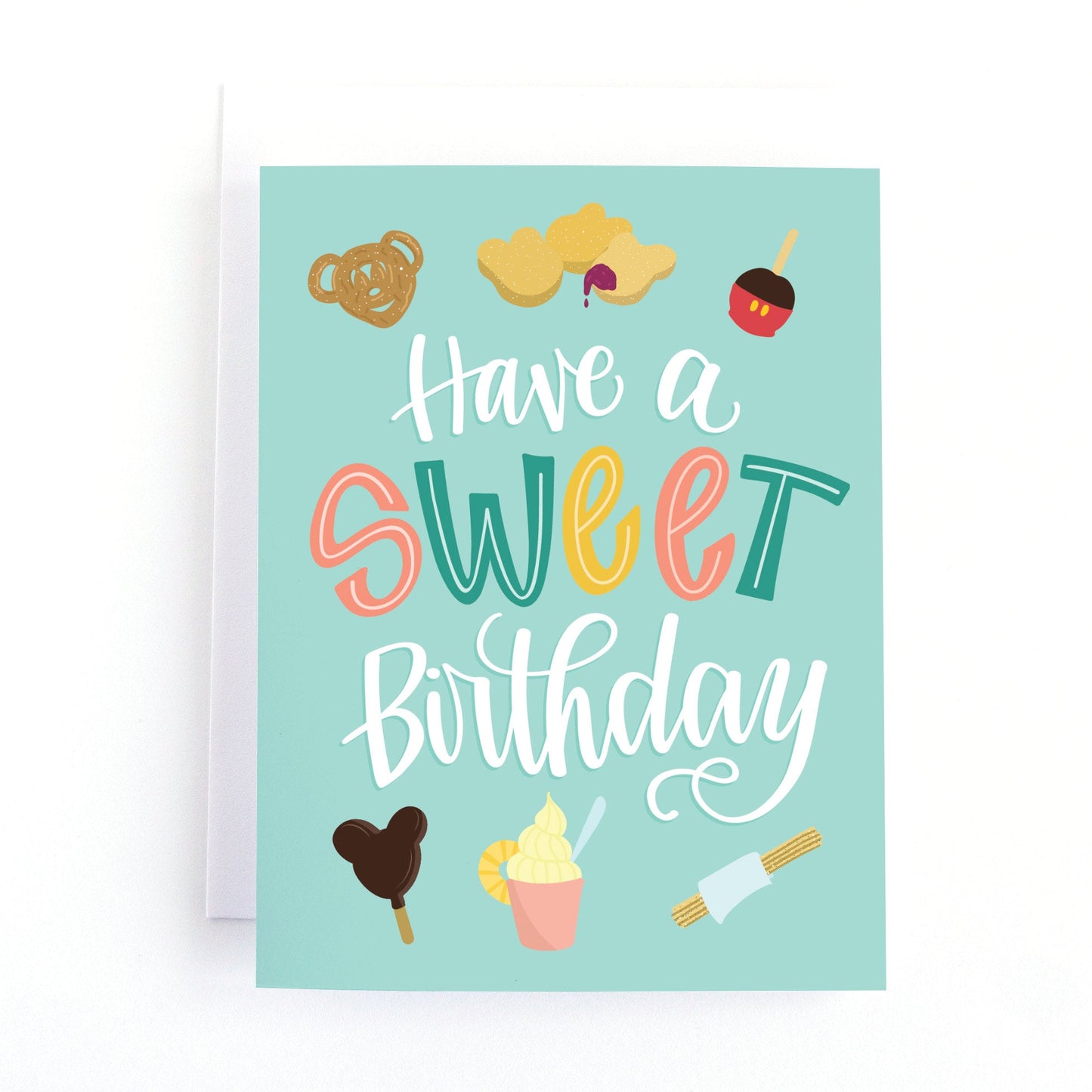 birthday card with illustrations of popular treats from  a famous theme park and the hand lettered text, have a sweet birthday.