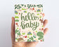 Baby Shower card with woodland forest illustrations including a squirrel, hedgehog and mushrooms and the message hello baby Scale
