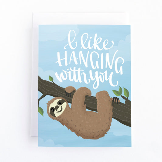 friendship card with a cute sloth hanging from a tree and the hand lettered greeting, I like hanging with you.