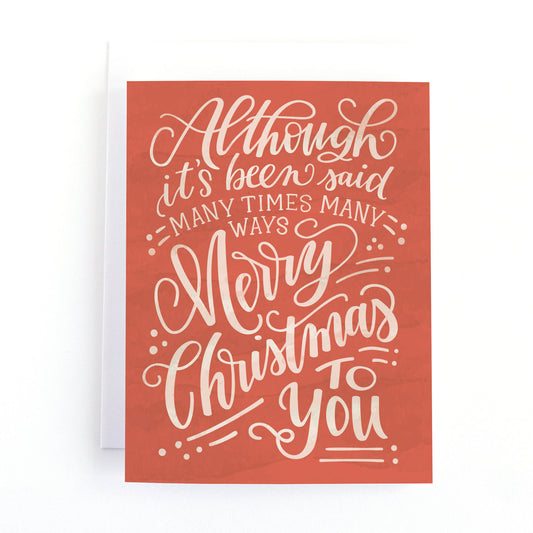 christmas card with elegant white hand lettering on a red background with the lyrics of a traditional christmas carol