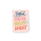 mini christmas card with multicoloured hand lettering on a pink background that says, Joyful, Peaceful, Merry and Bright.