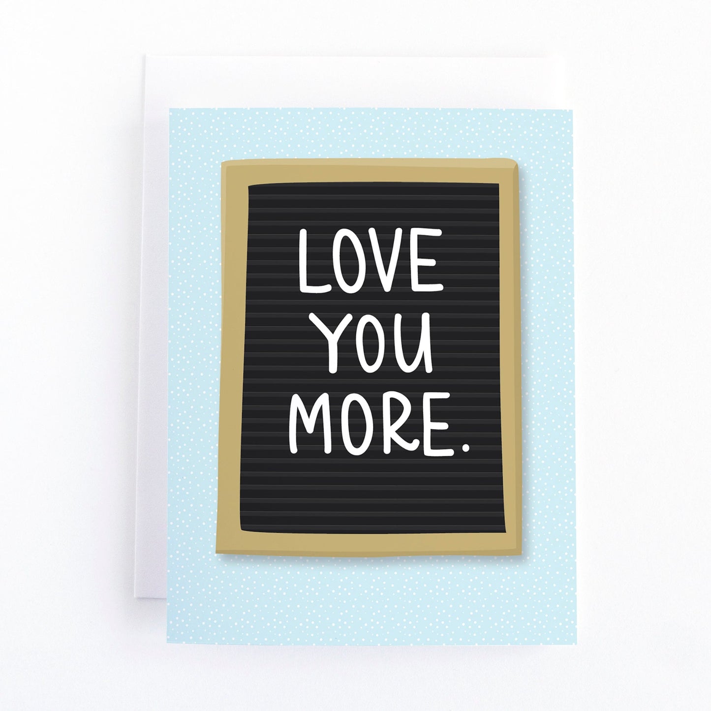 Valentines card with the message, Love you more written on a letterboard sign.