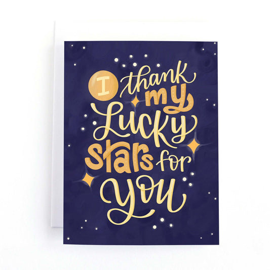 Valentine's day card featuring a starry sky with the hand lettered text, I thank my lucky stars for you.