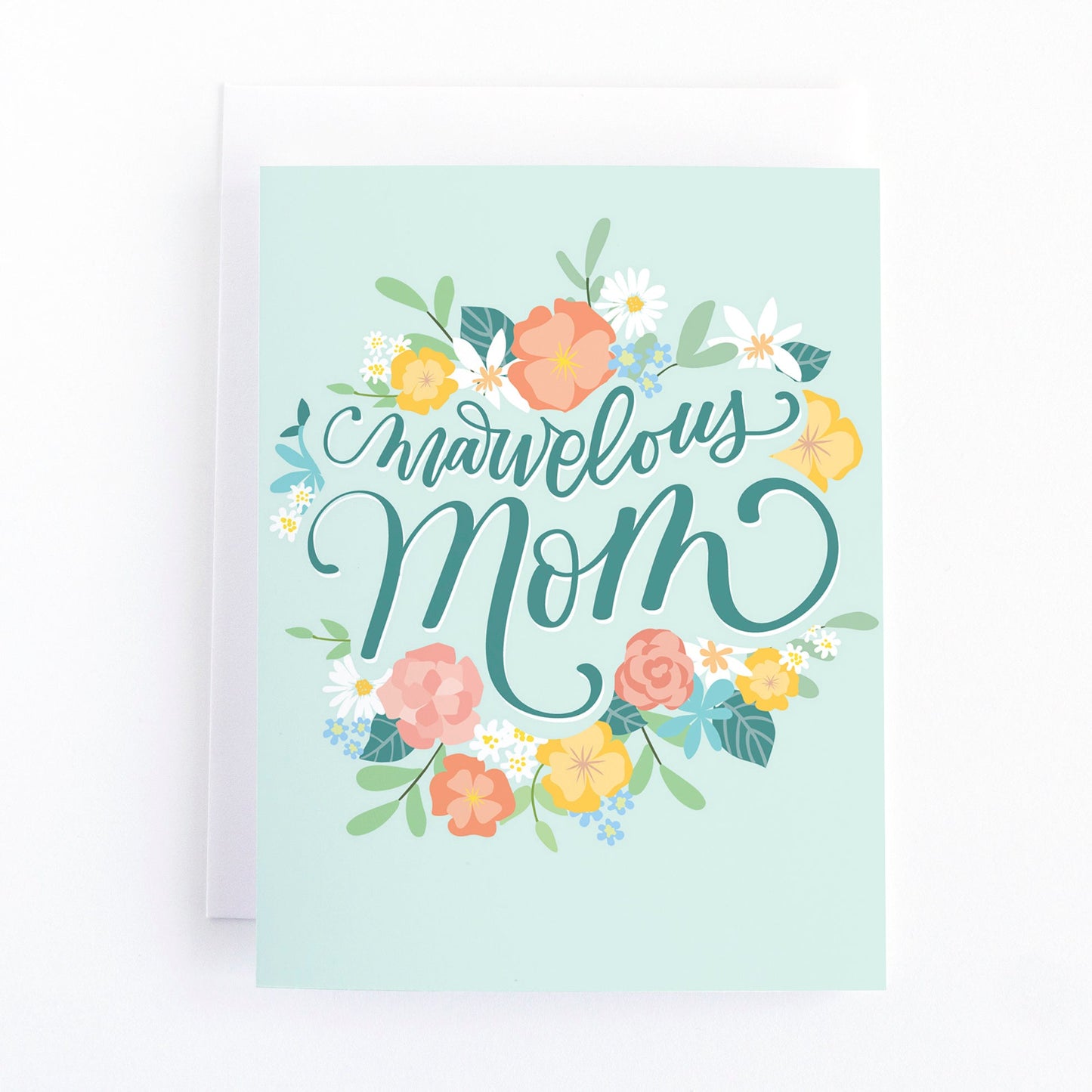 Mothers day card with a bouquet of flowers surrounding the hand lettered text, Marvelous mom on a light blue background.