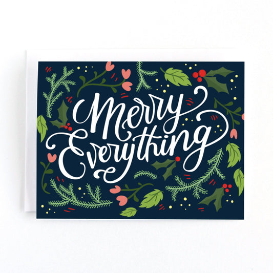 Christmas holiday card featuring flowers and greenery around the hand lettered message Merry Everything
