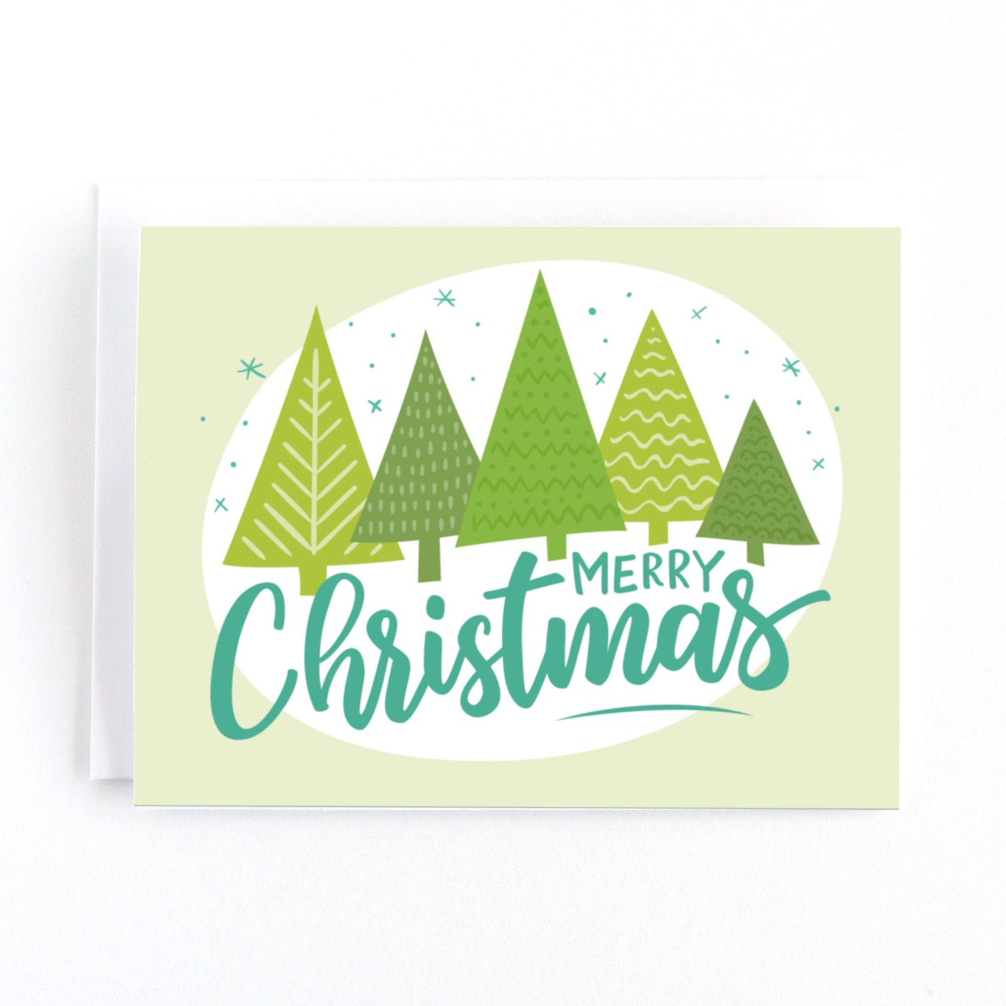 Christmas card featuring modern stylized christmas trees and the hand lettered greeting, Merry christmas