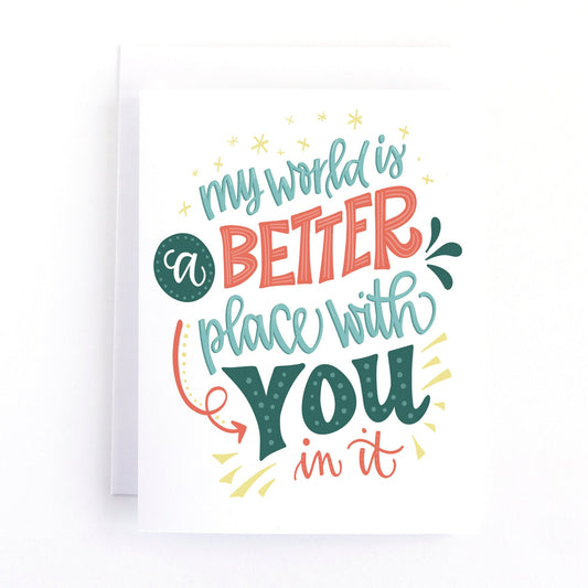 valentine's day card with playful red and green lettering and the text, my world is a better place with you in it.