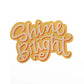 vinyl sticker with warm sunny colours and the text, shine bright.