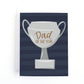 Father's day card with a silver trophy on a striped navy background that says, Dad of the year.