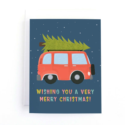 Christmas Card featuring a vintage red van with a christmas tree on the roof and the message wishing you a very merry christmas in multicoloured lettering