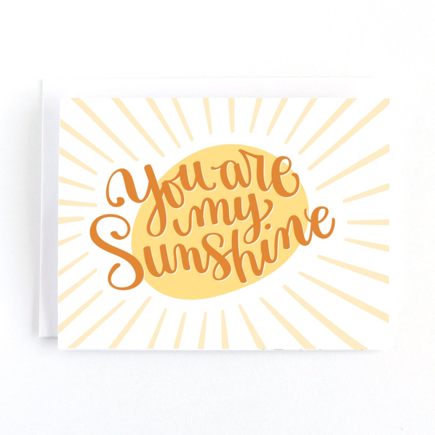 White and yellow greeting card with lettering that says you are my sunshine over top of a golden sun